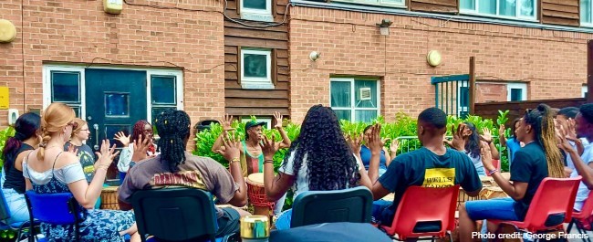 Students learning with virtuosic drum and dancer teacher Norman 'Rubba' Stephenson, of Afidance.  Photo credit: George Francis